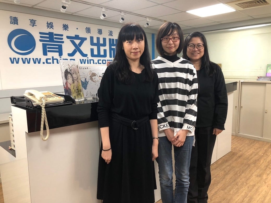可能是 3 個人、大家站著和室內的圖像