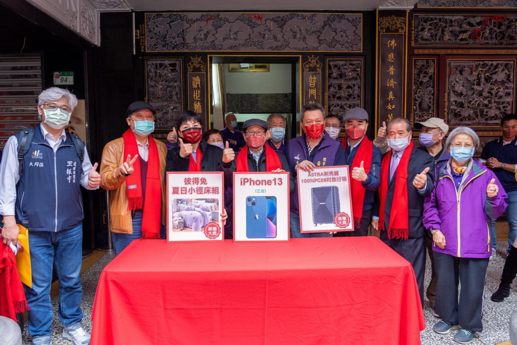 台北後站批發商圈發展促進會黃惠珍理事長(第一排左3)、臺北市政府產業發展局林崇傑局長(第一排左4)、臺北市華陰街徒步區發展協會黃世輝理事長(第一排右4)於華陰街普濟寺抽出商圈大獎知名床包組、高級行李箱及大獎iphone13並與現場貴賓大合照