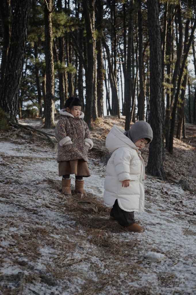 children on snow in forest