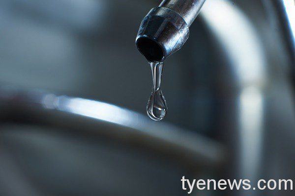 Reverse osmosis filter tap closeup with dripping water-drop.