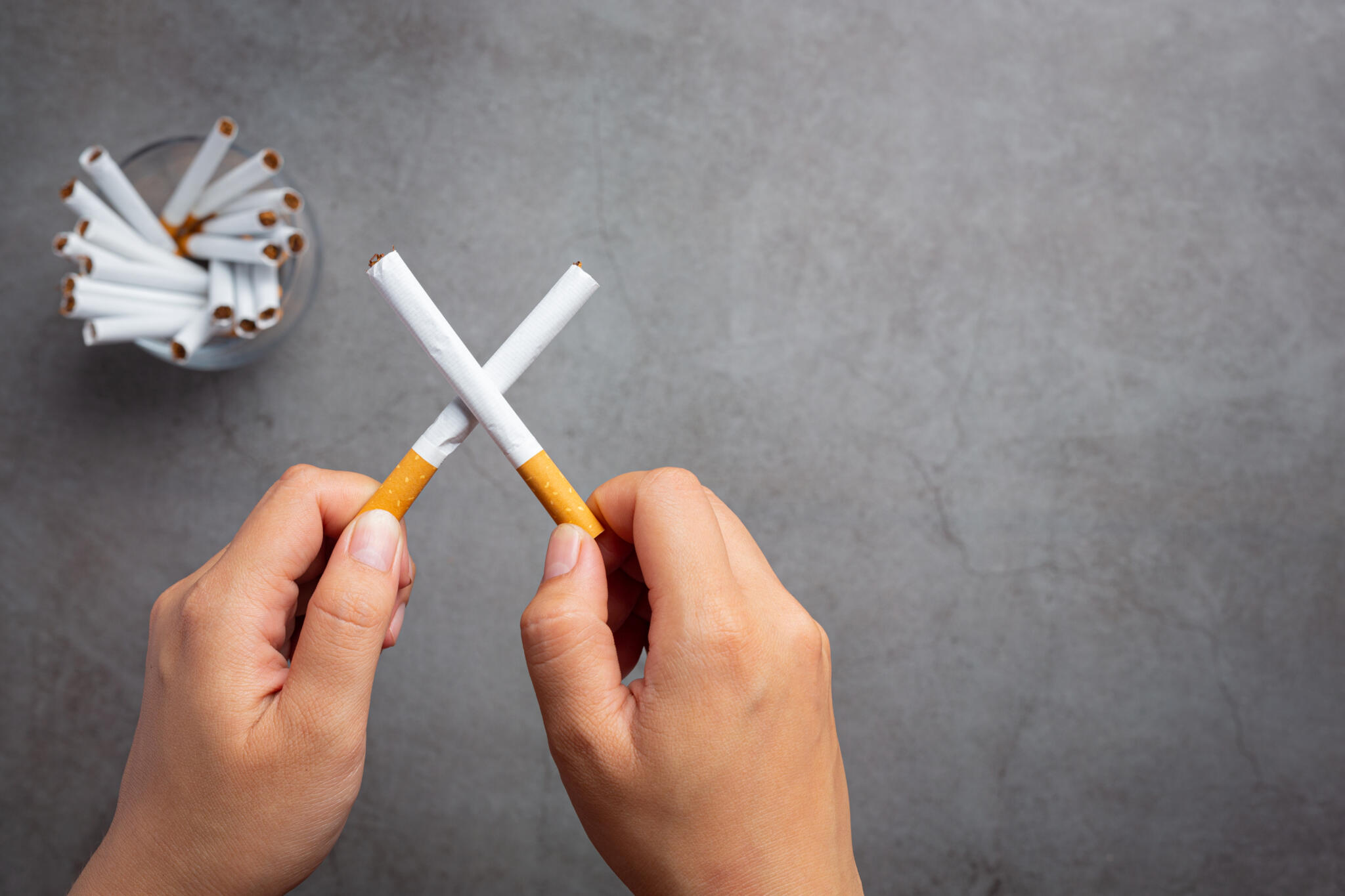 human hand holding cigarette world no tobacco day concept