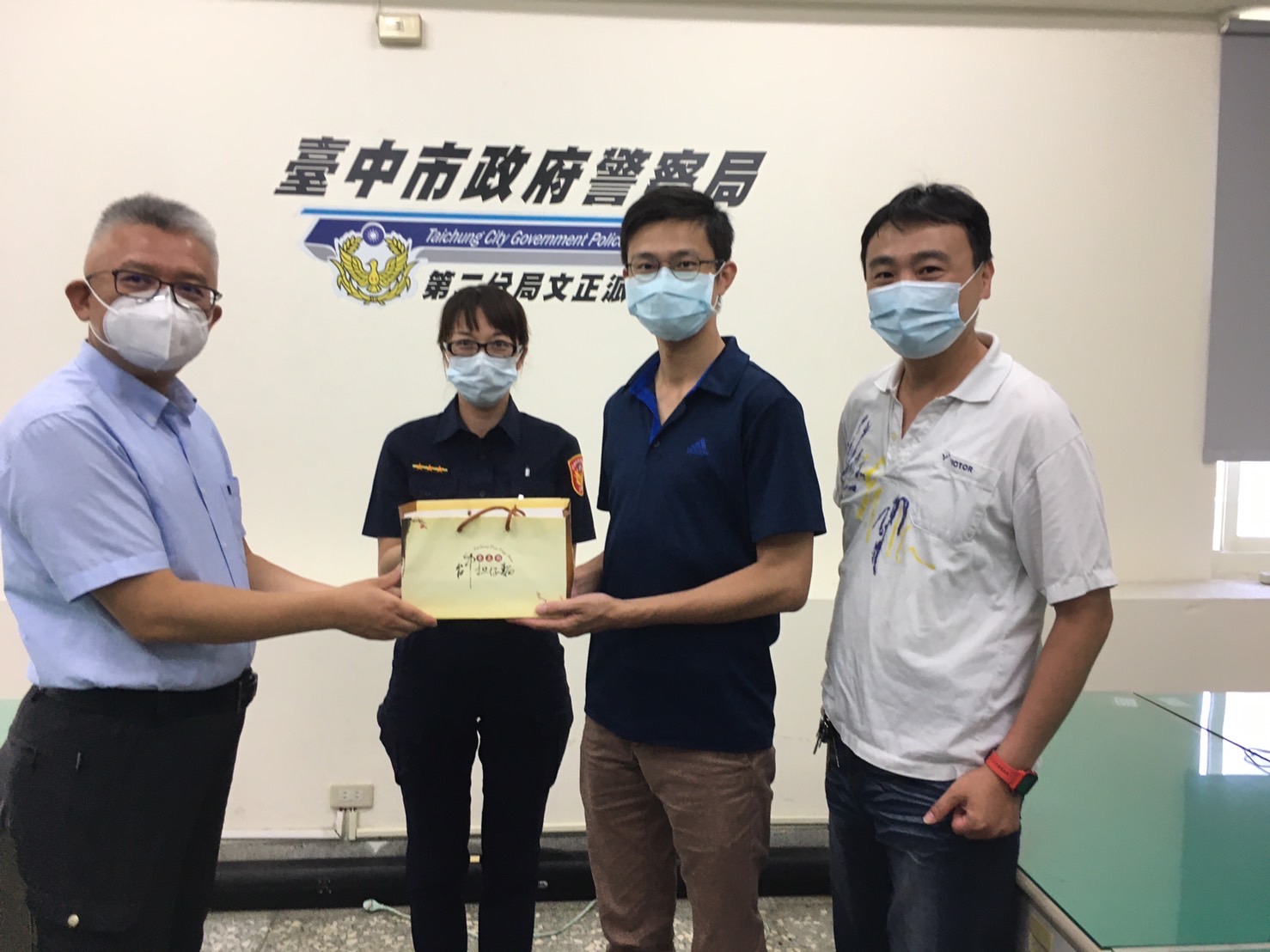 圖片說明:第二分局副分局長黃有富代表頒贈美味肉粽慰勞文正派出所員警,由所長李健瑋代表接受。 (記者江雁武翻攝)