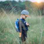 toddler holding camera