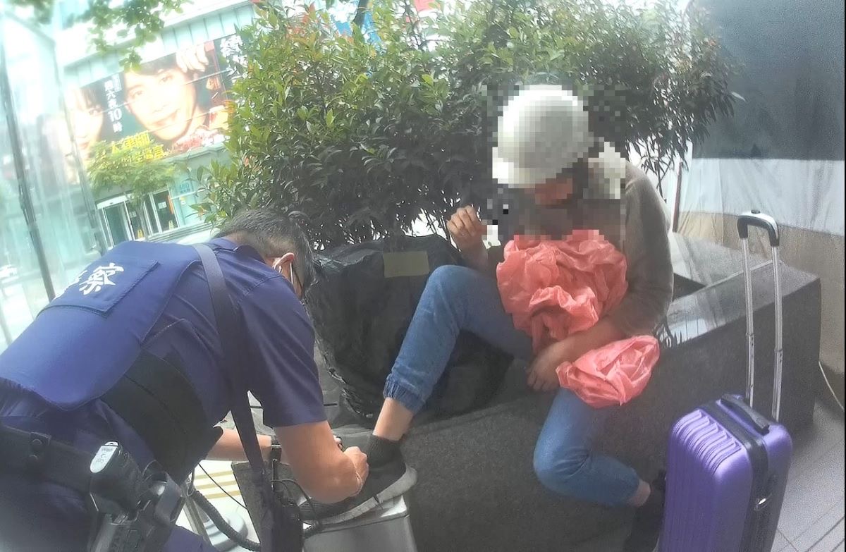 圖片說明:蔡副所長替少年繫上鞋帶並耐心安撫情緒。(記者宋紹誠翻攝)