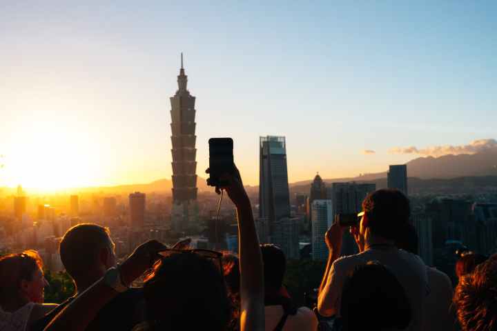 people taking photos of high rise buildings