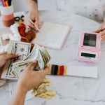 hands holding us dollar bills