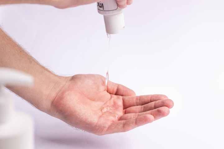 man applying antiseptic on hands for protection from infections