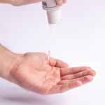 man applying antiseptic on hands for protection from infections