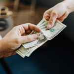 hands holding us dollar bills