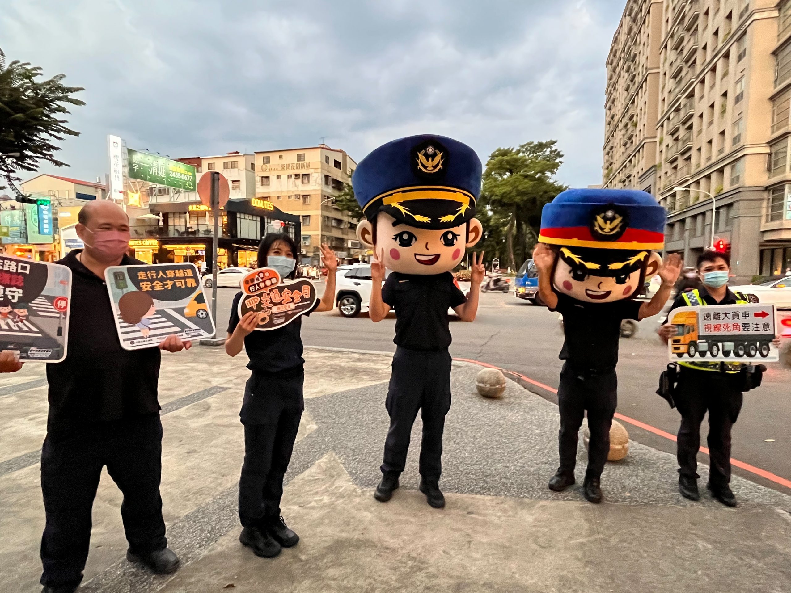 圖片說明:中市警二分局大頭娃娃現身宣導臺中市北區易肇事路口,要你平平又安安!(記者林㤈輝翻攝)