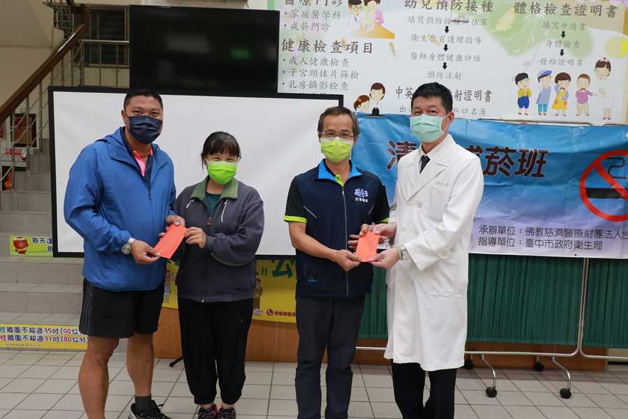 陳慶元主任(右一)頒獎給戒菸成功的高先生;林瑞文里長(左一)加碼感謝高太太的支持。