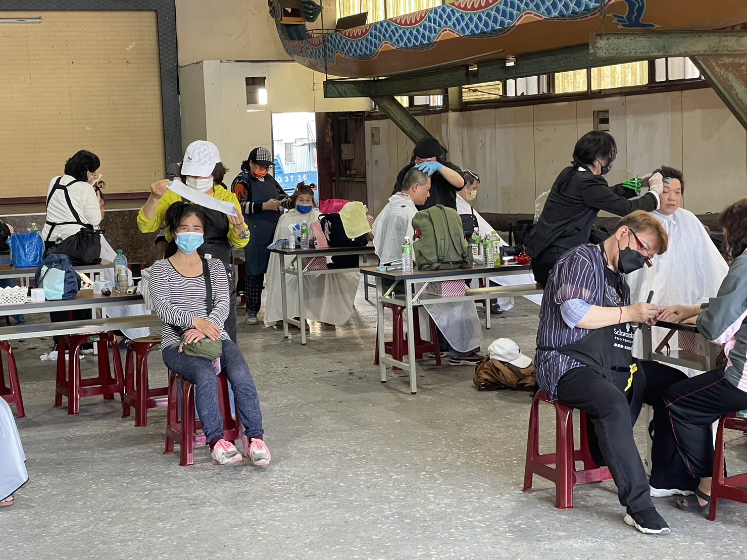 愛心義剪活動,不接受任何方式預約,到場接受愛心義剪服務的里民都是現場領到號碼牌後,耐心等待叫號。(記者朱珈瑩攝)