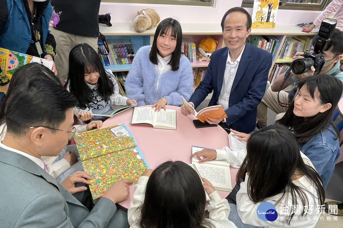 新興國小玉山圖書館落成啟用,桃園市政府教育局長劉仲成與小朋友們一起閱讀。