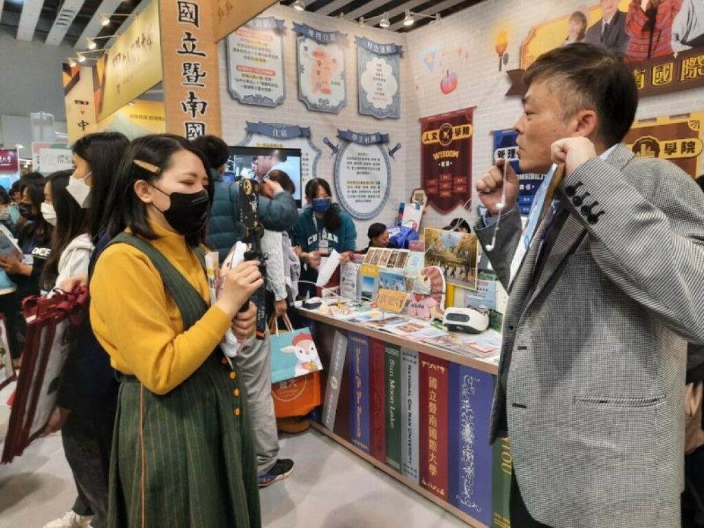 暨南大學副校長楊洲松（右）在展區直播中，為準大學生線上回覆詢問。