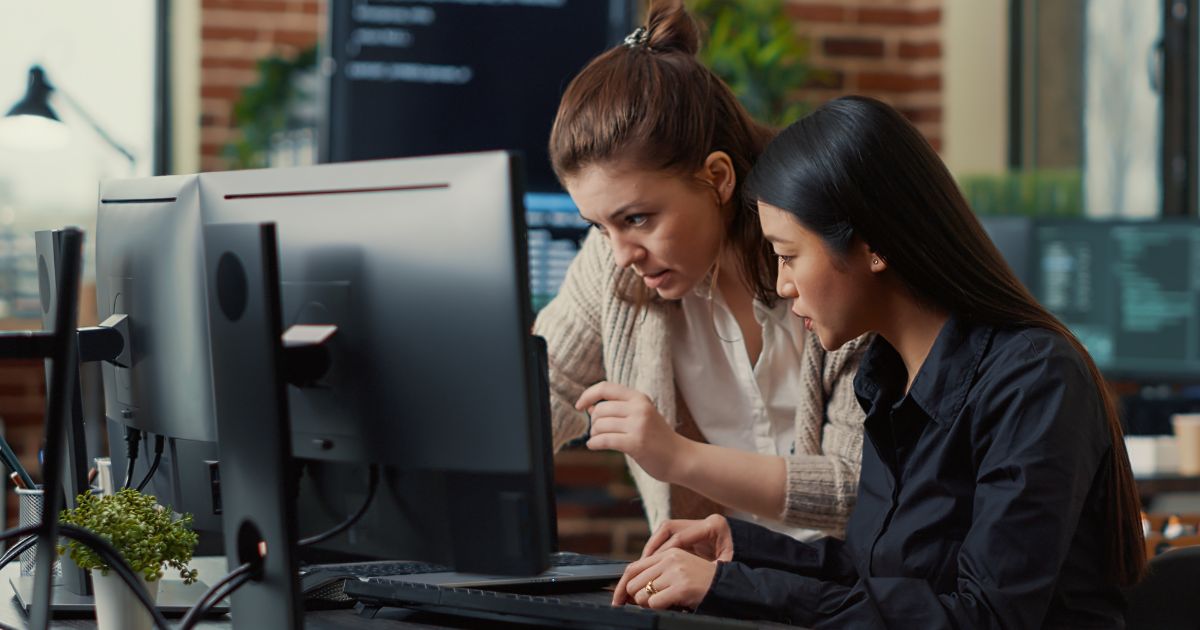 1200-team-coworkers-comparing-source-codes-running-laptop-screen-computer-monitor-it-development-office-software-developers-collaborating-data-coding-group-project-while-sitting-desk