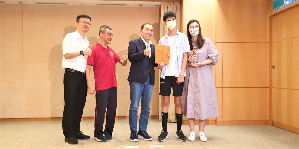 《圖說》龍埔國小林義宸(右2)獻獎予侯友宜市長(中),侯友宜致贈滿願獎金。〈教育局提供〉