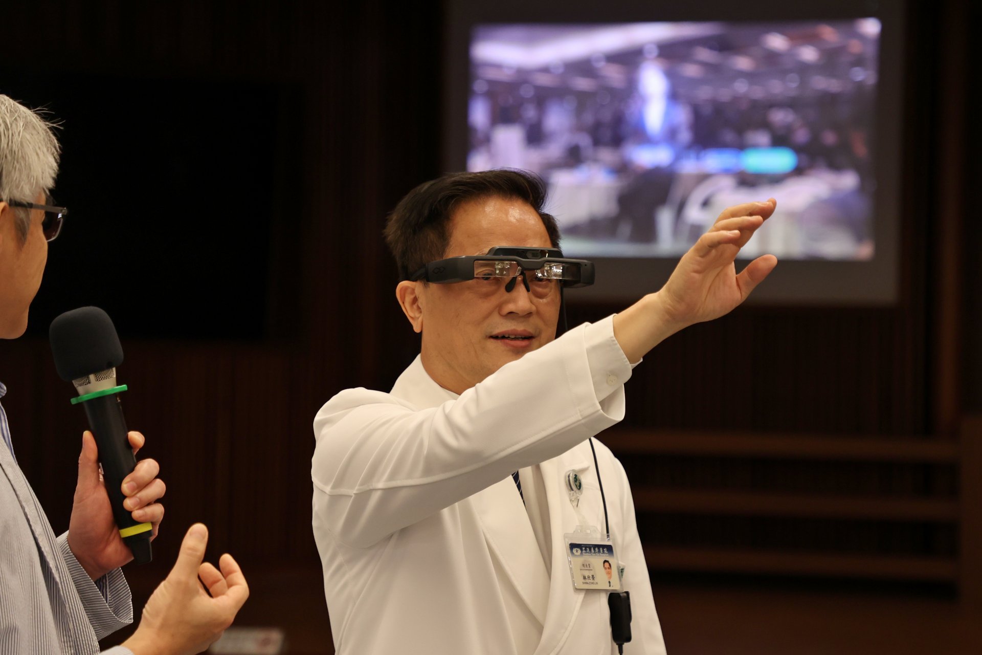 林欣榮院長戴上AR眼鏡,體驗「AR智能解說員」,不僅可以向民眾推廣捐贈造血幹細胞的善舉,並解答相關問題以及釐清可能的疑惑。