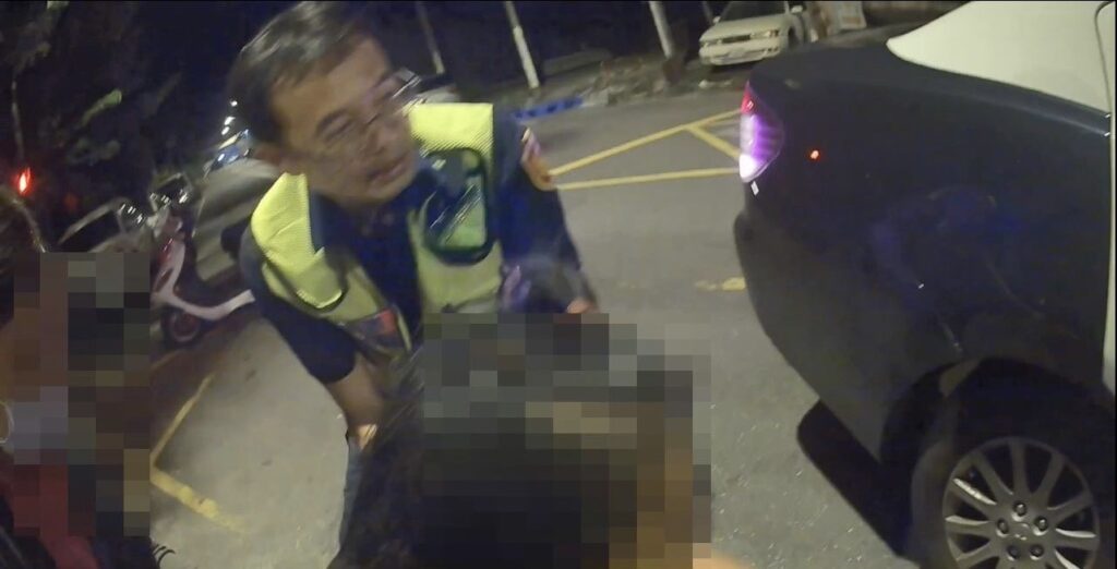 行動不便的女子跌坐在馬路中,員警立即上前將其攙扶至路邊並協助示警後方車輛