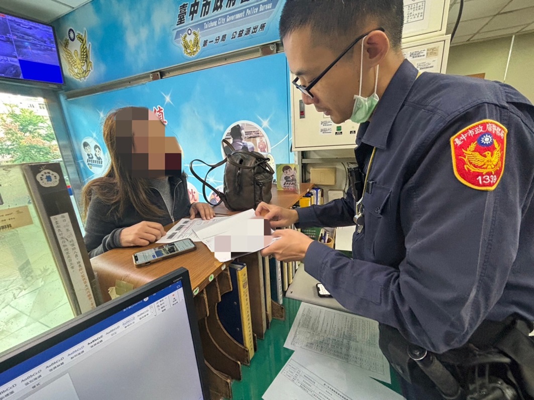 ▲圖說:公益所警員李文詳快速掃描文件,再以流利英文向外籍女安琪拉說明 (圖/台中市政府提供)
