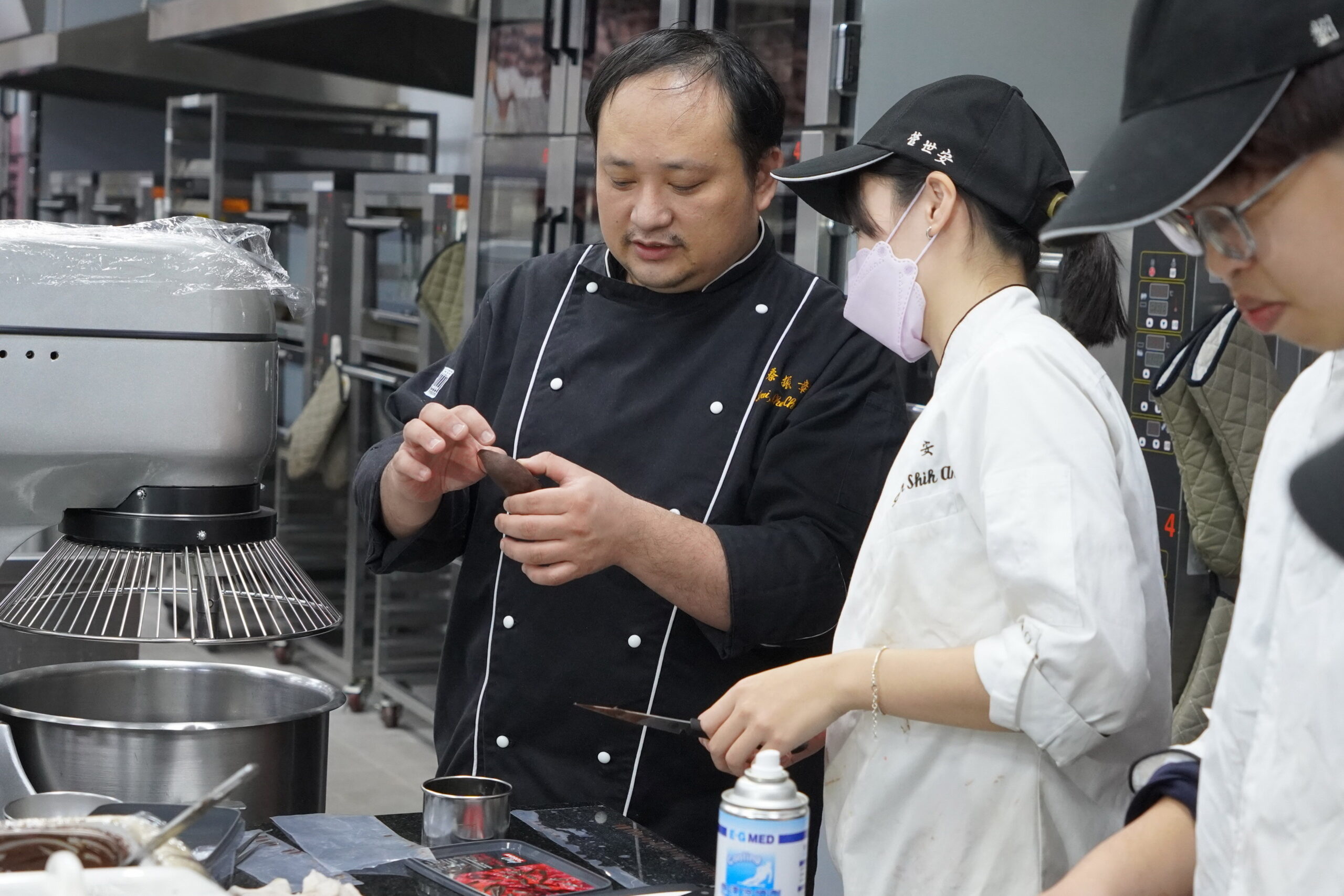 ▲大葉大學烘焙學程蔡振彰老師(左)指導學生製作巧克力工藝。（記者張溎壕攝）