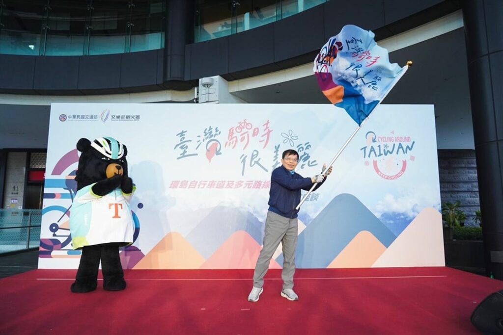 交通部王國材部長揮動「臺灣騎時很美麗」旗幟。圖/交通部觀光署