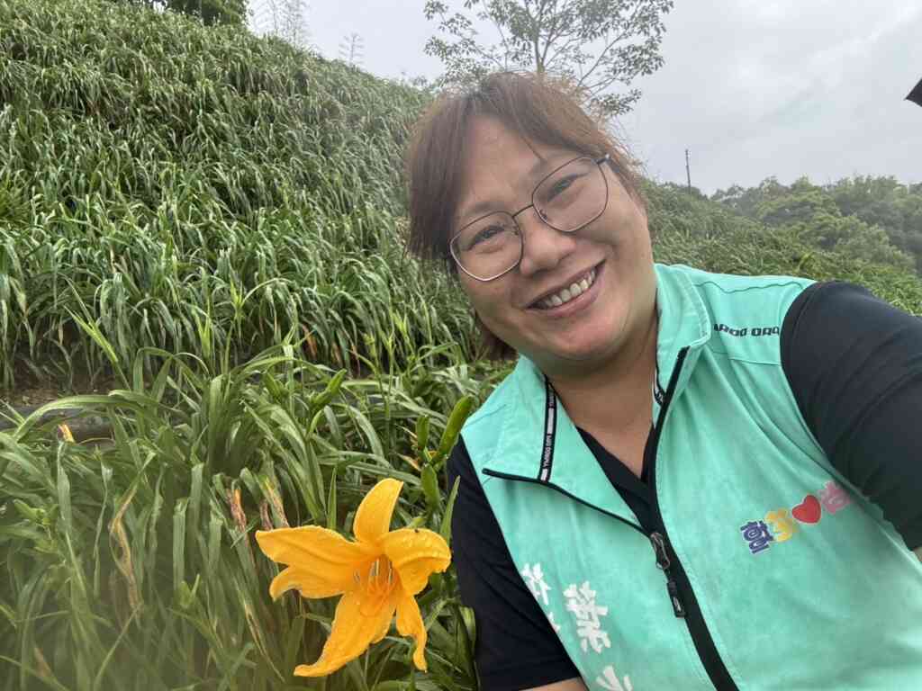 ▲花壇鄉代葉尚雯與今年花壇虎山巖金針花第一朵花開合照。（記者林明佑翻攝）