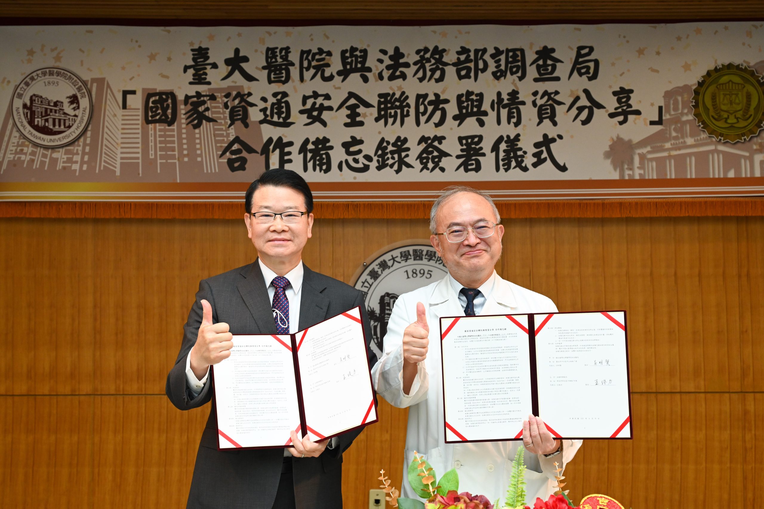 調查局長王俊力(左)與臺大醫院院長吳明賢簽署備忘錄後合照。(記者張欽翻攝)