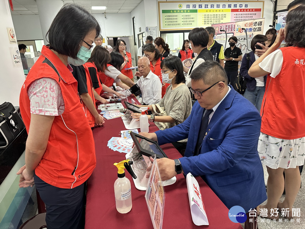 扶輪社長等來賓體驗心房顫動量測。(記者扶小萍攝)
