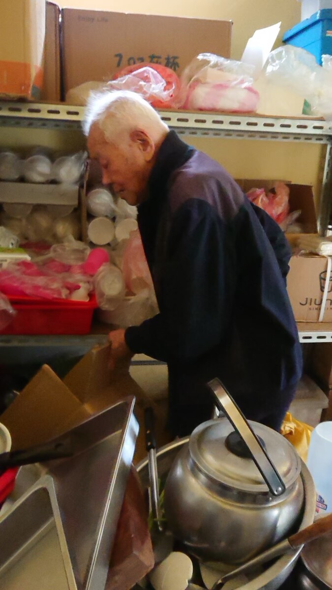 ▲陳萬船先生年輕時可說是叱吒一方、霸氣十足,圖為他進廚房幫忙時被志工拍下。(圖/東海龍門天聖宮 提供)