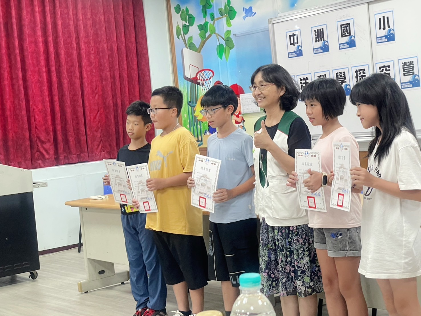 ▲南高雄家扶中心主任郭淑美頒發夏令營結業証書給學員們。（圖/中洲國小提供）