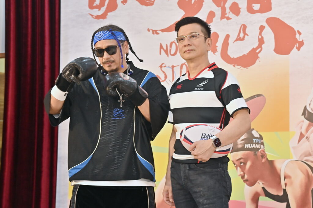 世壯運主題曲音樂統籌陳子鴻特別穿上球衣出席，和主唱人葛西瓦在記者會上拿起橄欖球和拳擊手套，重溫青春運動夢想。(臺北市政府文化局 提供)