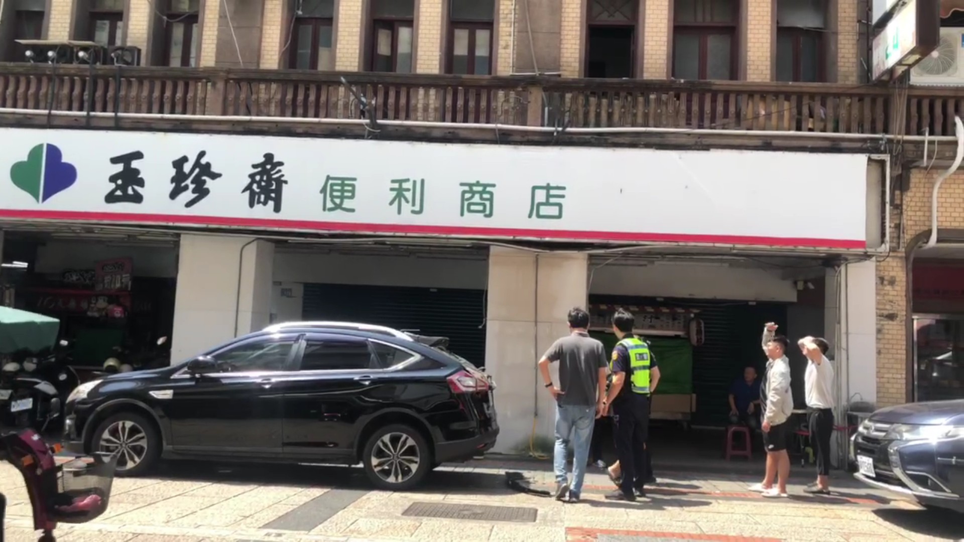 ▲鹿港鎮民族路口的百年老店玉珍齋發生疑是屋簷脫落的水泥塊，砸到停在路邊的一輛休旅車，造成後車廂擋風玻璃破個大洞。（記者張溎壕攝）
