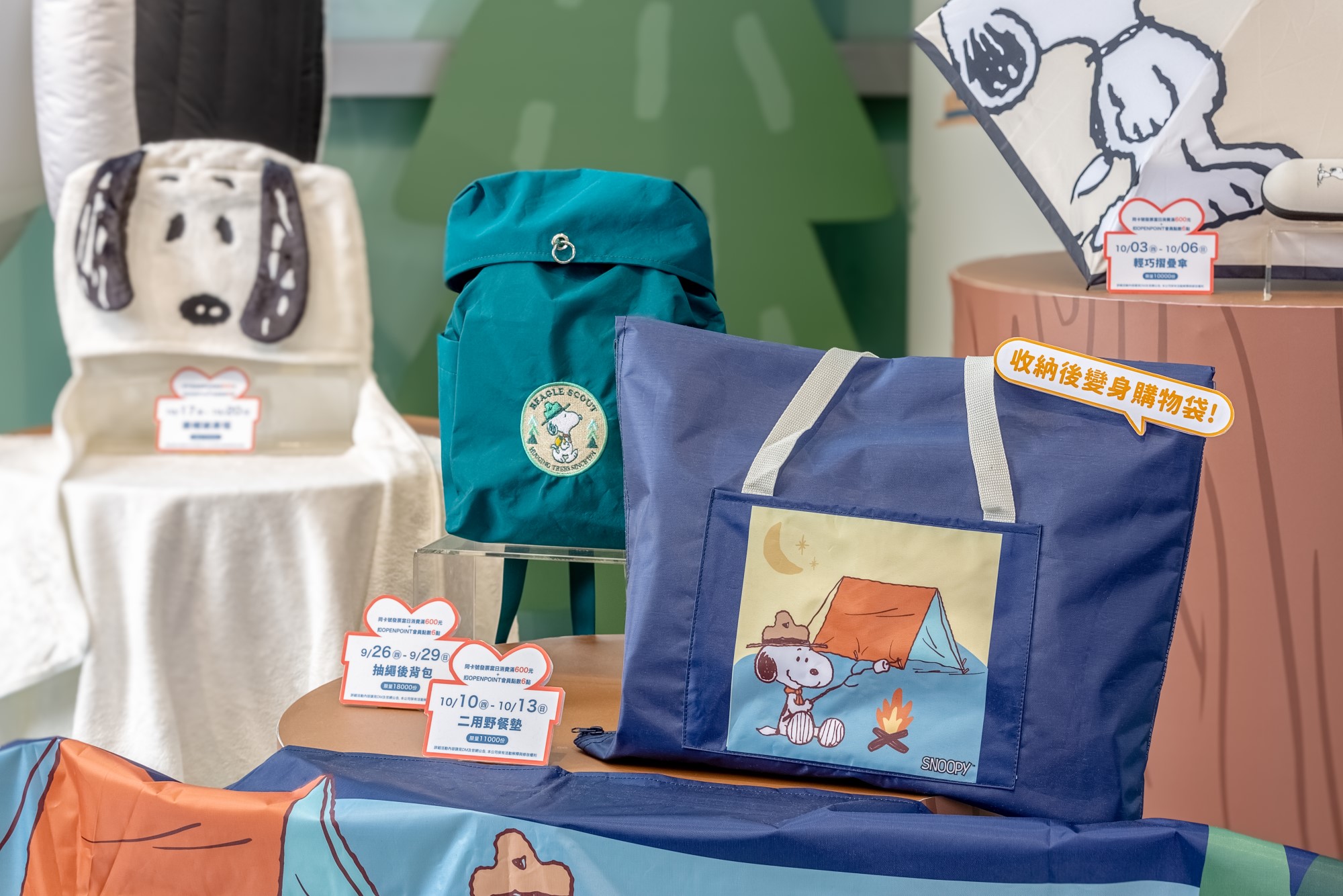 ▲超強週年慶來店禮-SNOOPY抽繩後背包、二用野餐墊及連帽披肩毯。（圖/高雄夢時代提供）