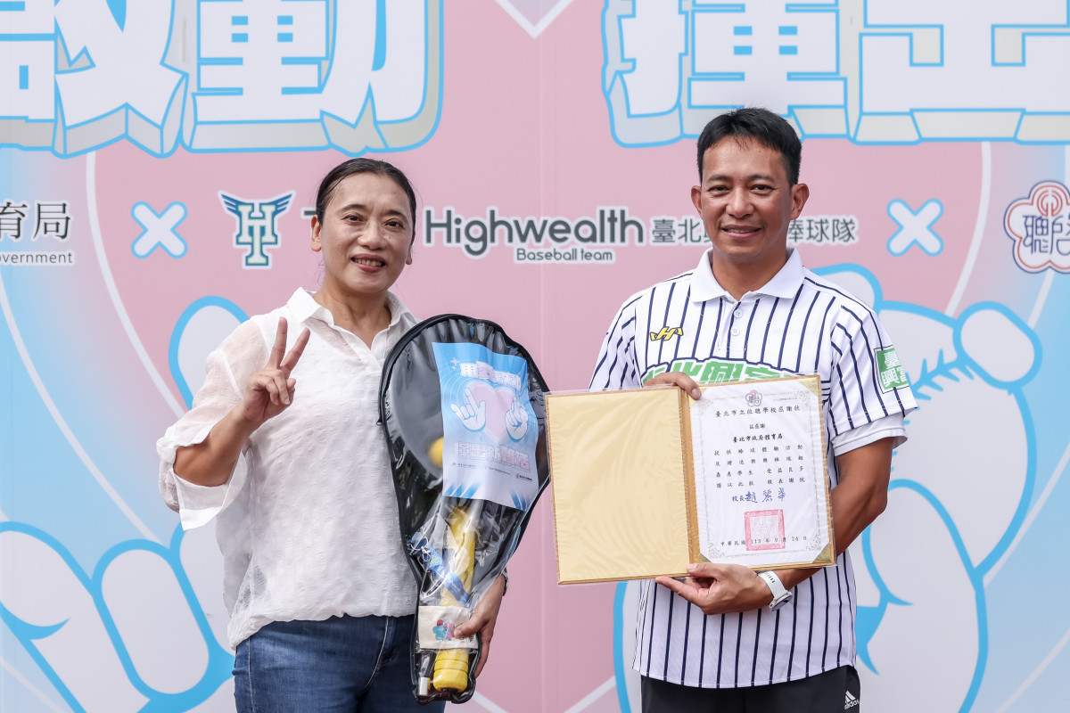 臺北市政府體育局羅國偉專委(右)致贈樂樂棒球組予北市啟聰學校趙麗華校長,鼓勵學生們揮出屬於自己的新生活,勇敢追求自我。