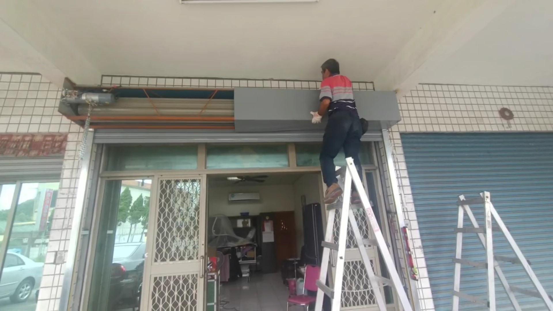 ▲好德做工行善團協會和慈化慈善會志工為二林鎮弱勢男子更換故障的鐵門。（記者張溎壕攝）