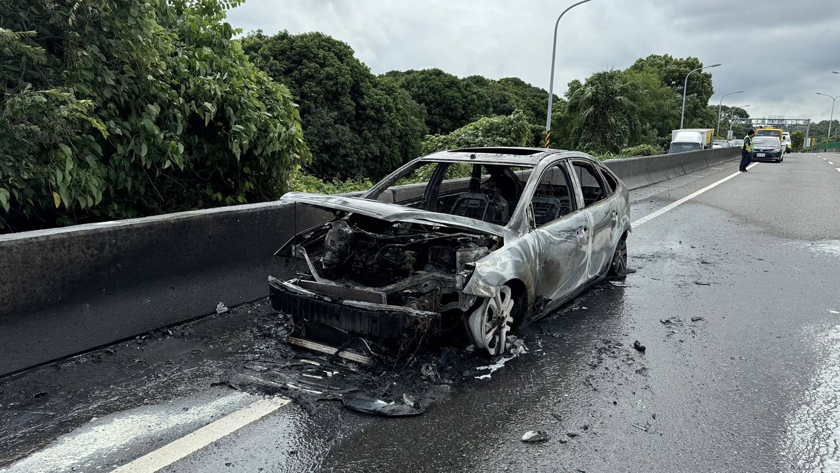 ▲彰化市省道台74甲線東外環道發生火燒車，1輛轎車行駛途中突然竄煙並起火燃燒，整部車被燒到剩下骨架。（彰化縣消防局提供）