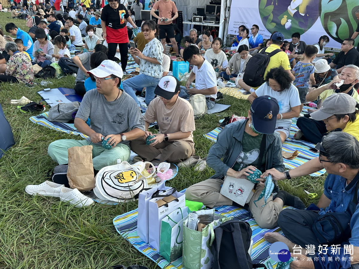 操場上許多民眾努力的將茶球團緊。(記者扶小萍攝)