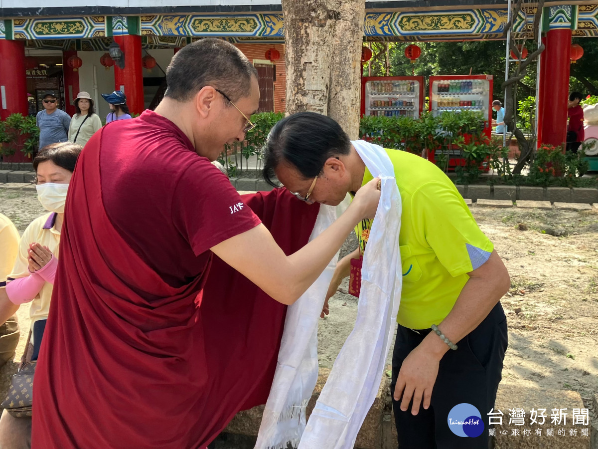 仁波切在八卦山曬大佛現場為彰化市開化寺管理人林世賢加持披上哈達。圖/記者鄧富珍翻攝