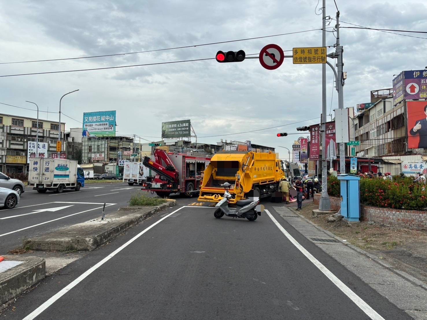 ▲彰化市中華西路與崙美路口發生一起垃圾車與機車擦撞意外，機車騎士摔倒，並被垃圾車夾住左小腿，消防人員用破壞器材搶救。（民眾提供）