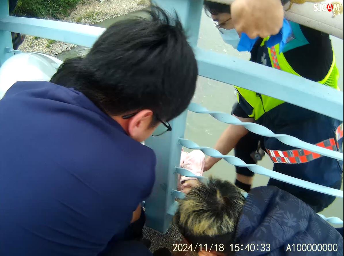 ▲女碩士生企圖從橋上跳下，彰化警分局員警陳驄勝在千鈞一髮之際飛撲死命抓住，成功救回一命，陳驄勝右手卻因此拉傷。（警方提供）
