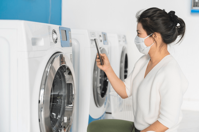 桃市推動自助洗衣店安全管理條例 嚴控風險加強監管 70 portrait female wear virus protecting mask spread covid19 washing blue color interior laundry shop condoiminuim city new normal lifestyle