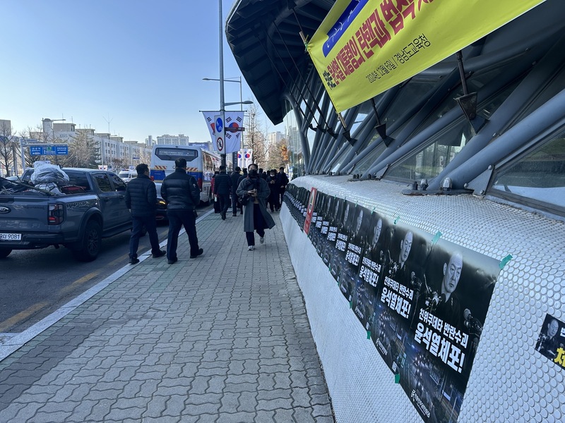 韓國國會14日下午第2次表決總統尹錫悅彈劾案,國會前道路旁貼滿支持彈劾的海報與標語。圖/中央社