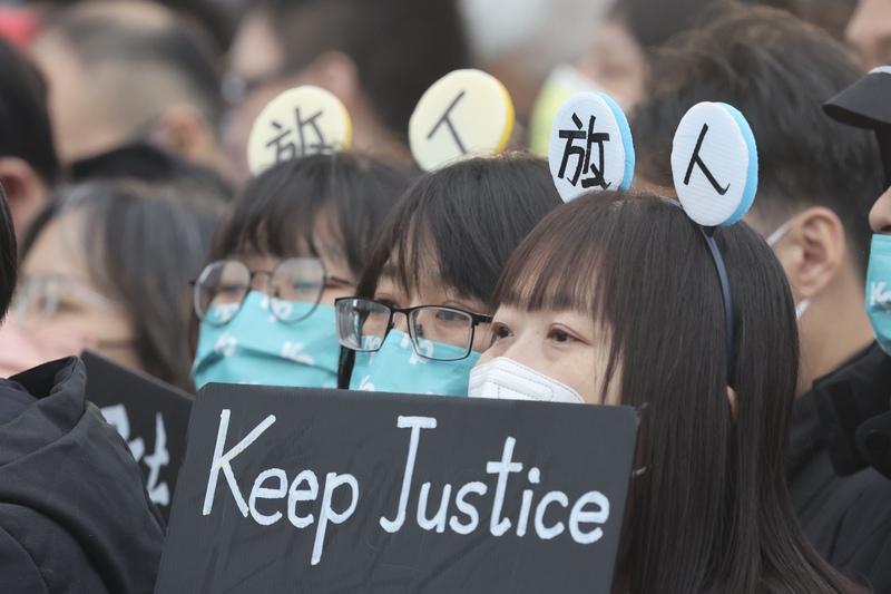民眾黨11日舉辦「釘孤枝」公民活動,現場不少年輕小草不畏寒風,齊聚高喊「綠色威權、司法不公」等口號,圖為支持者戴著「放人」字樣頭飾,為前民眾黨主席柯文哲聲援。圖/中央社