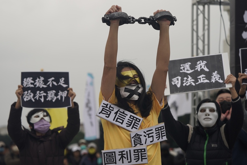民眾黨11日在自由廣場舉行「111釘孤枝!萬人捍衛司法正義」活動,支持者不畏寒風齊聚,並演出行動劇表達立場。圖/中央社