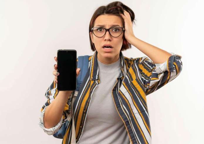 網購3C產品收750元審查費惹議 NCC這樣說 63 anxious young student girl wearing glasses back bag showing mobile phone putting hand head isolated white 1 scaled e1708487021471