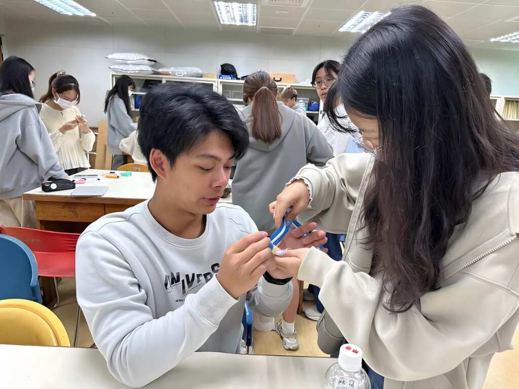 ▲課堂上製作穿扣輔具，幫助手指靈活度不佳之患者獨立穿衣。（中山醫大提供）