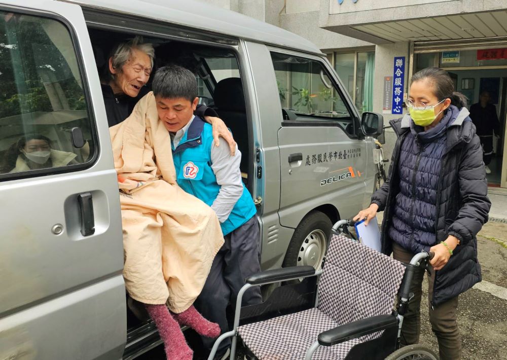 《圖說》臺北市榮服處榮欣志工小心翼翼抱劉伯伯下車。〈臺北市榮服處提供〉