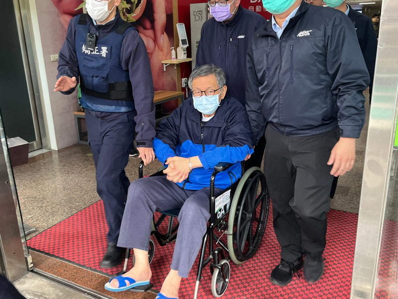 柯文哲3日下午坐著輪椅出院，在台北看守所人員戒護下離開醫院。中央社