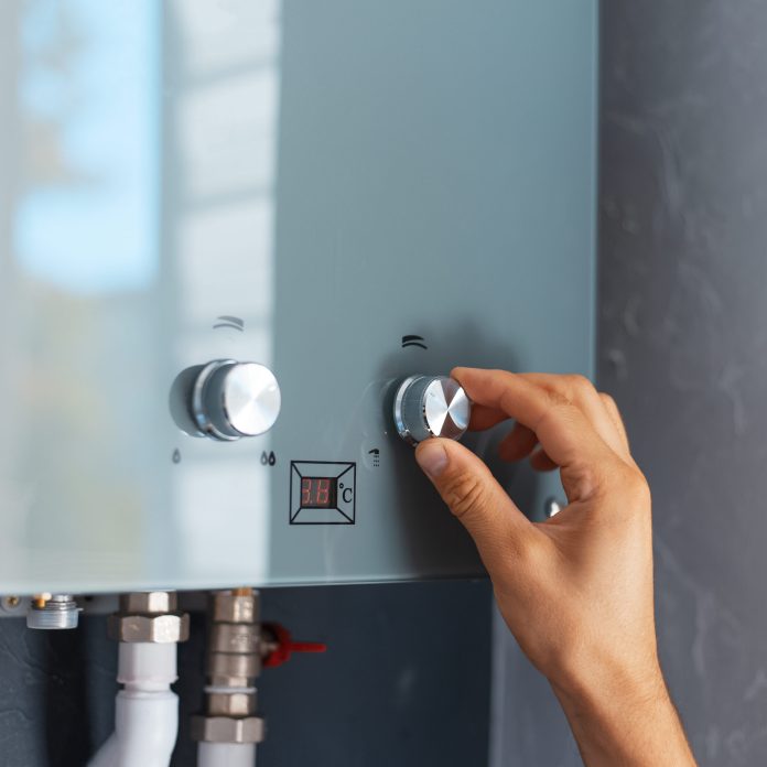 楊梅4名越籍移工命喪租屋處 疑熱水器釀一氧化碳中毒 74 close up male hand adjusting temperature water heater modern home gas fired boiler scaled