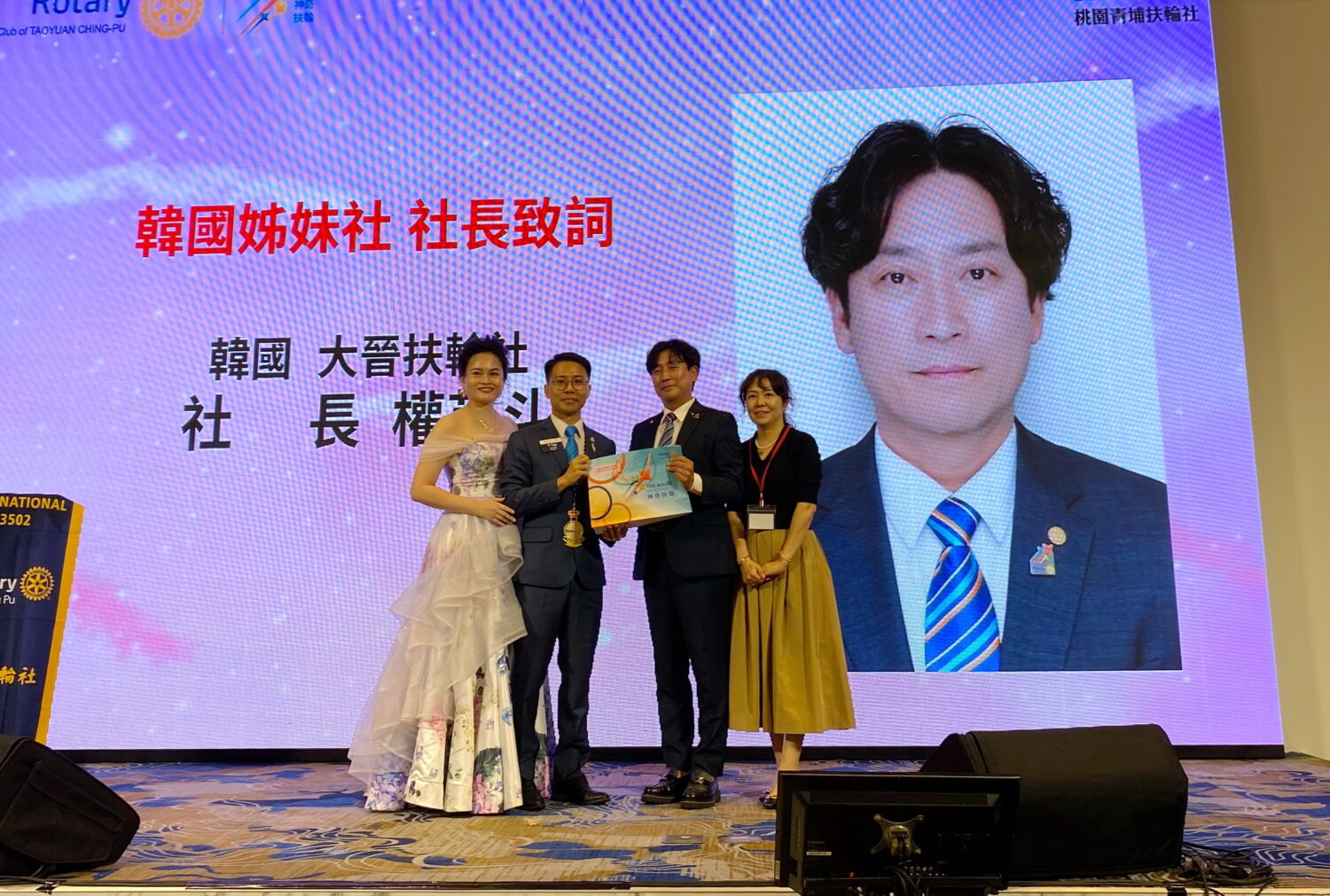 桃園青埔扶輪社社長黃聖翔伉儷致贈紀念品與權英斗夫婦合影。(記者包克明 攝)